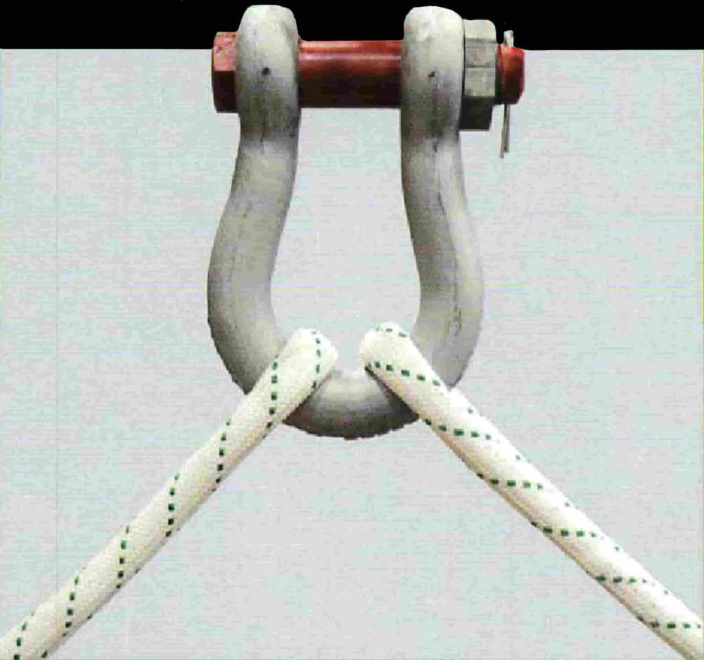 Rigging hardware featuring a steel shackle with two white ropes, illustrating essential components for efficient heavy lifting in construction and industrial applications.